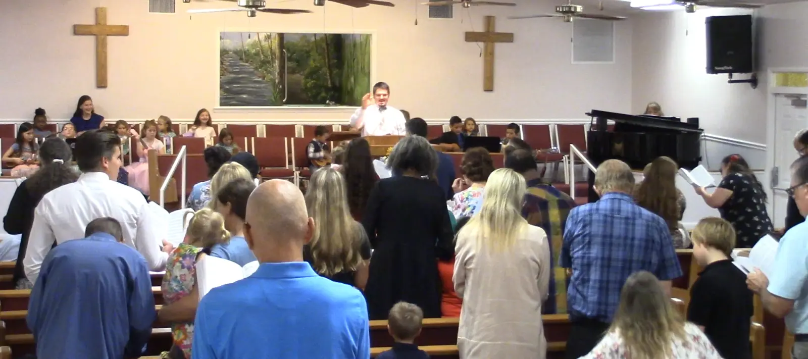 The congregation standing to sing with the children up front