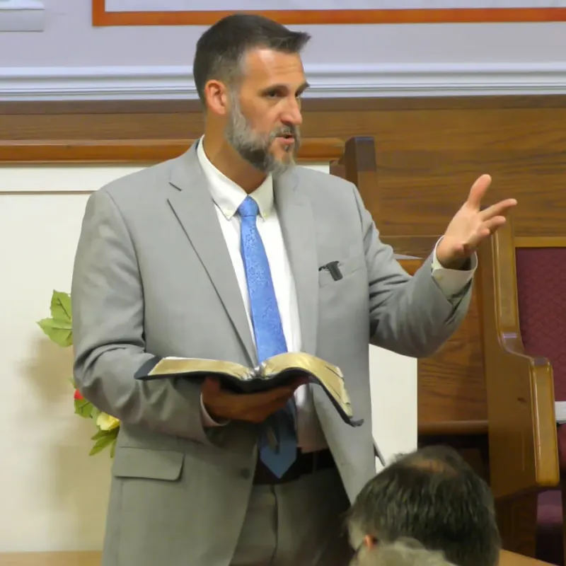 Pastor Fannin preaching with an open Bible
