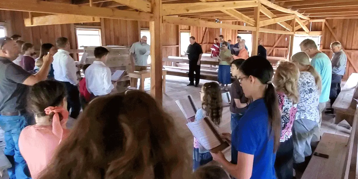 Families standing together singing hymns